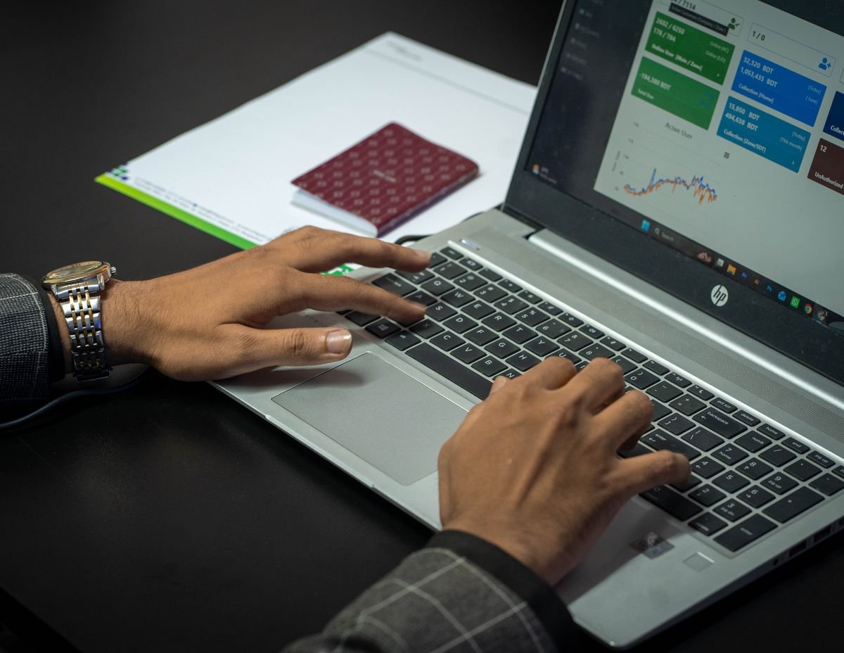 Hands on a laptop keyboard with a performance dashboard on screen