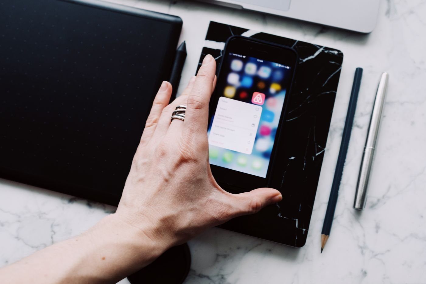 Designer reviewing a mobile app layout at a desk
