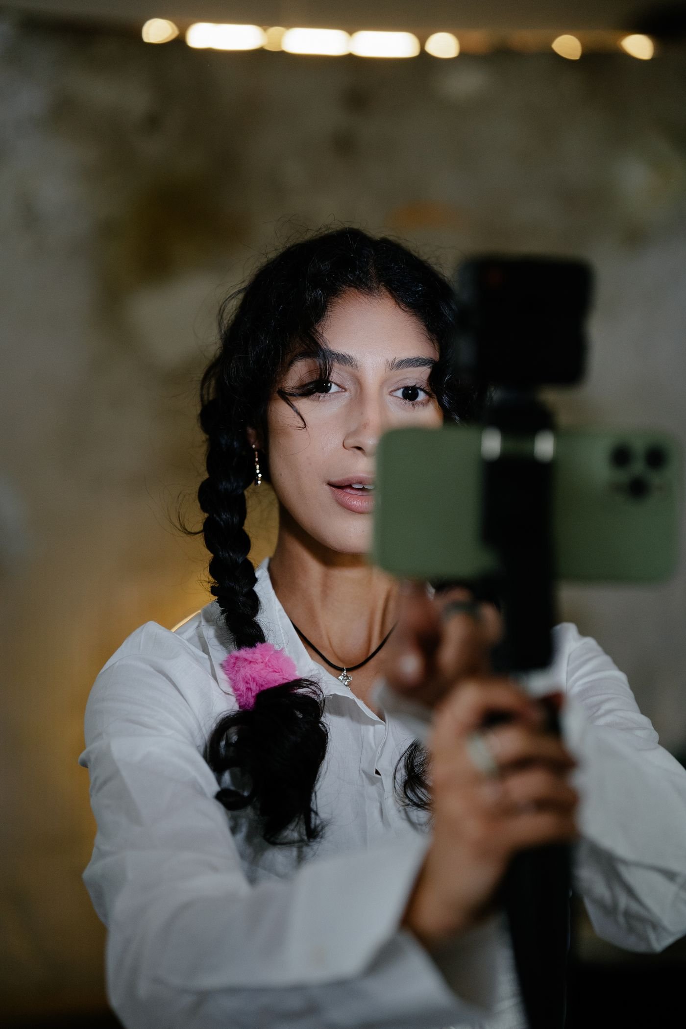 Content creator filming a short video on a phone stabiliser